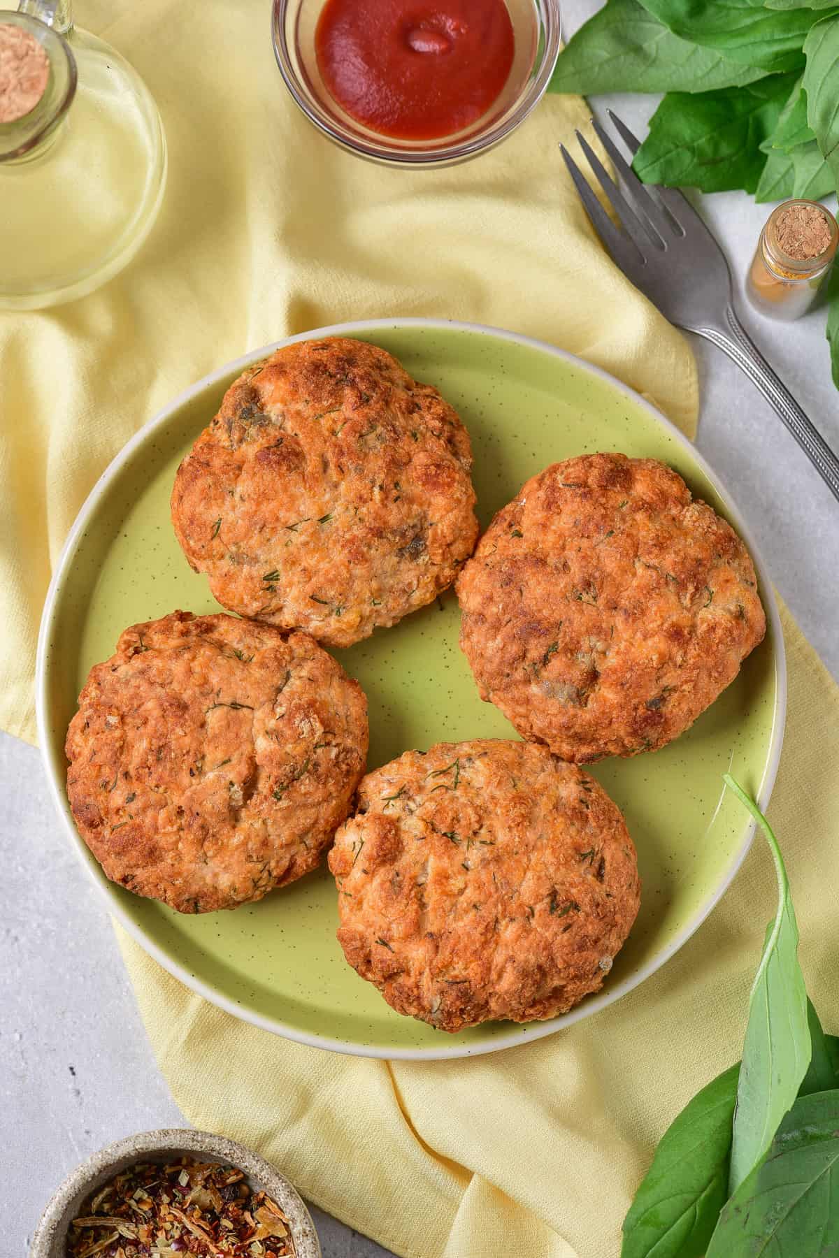 Plate with four cooked salmon patties.