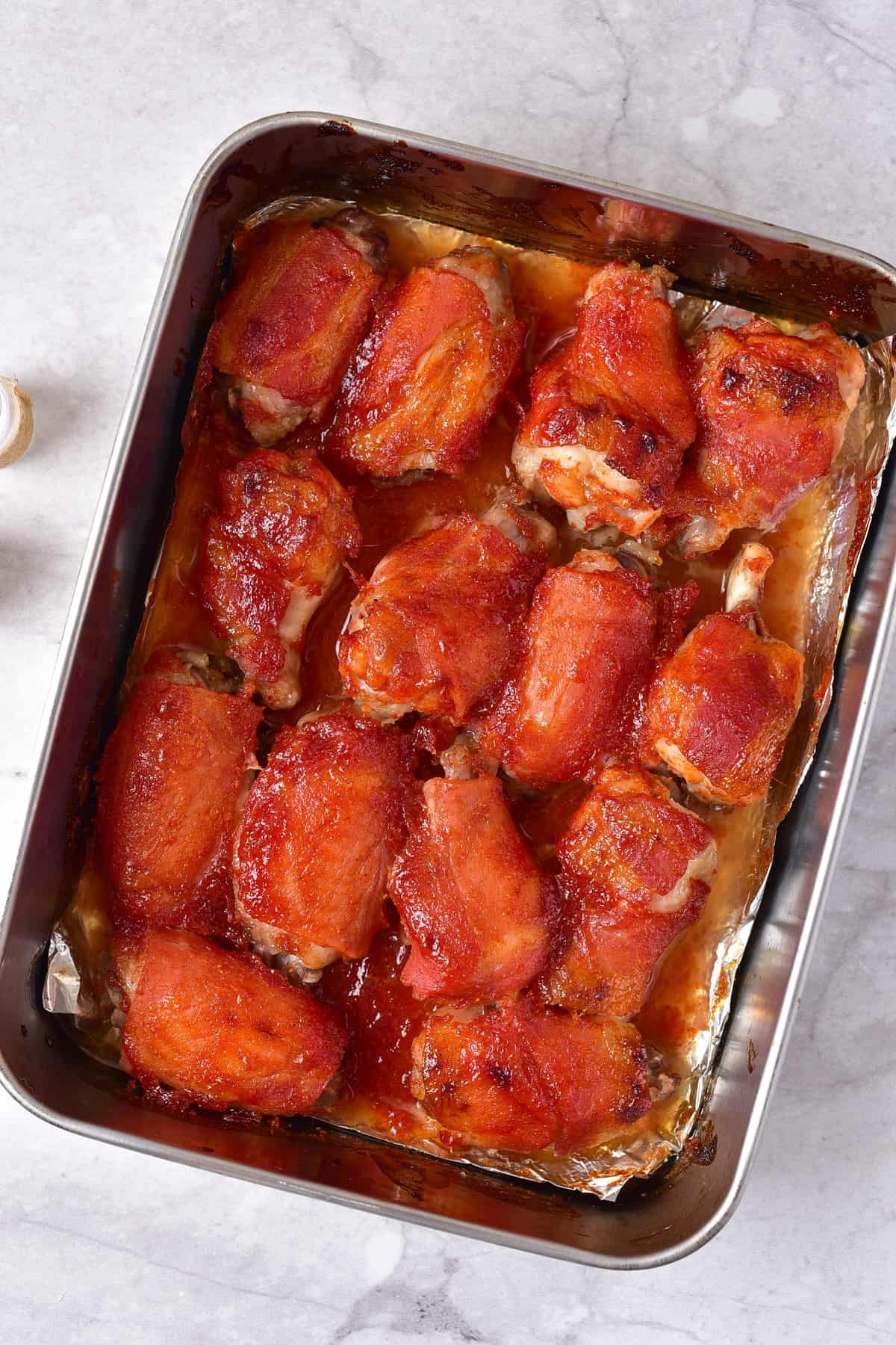 Dish of baked buffalo bacon wrapped wings.