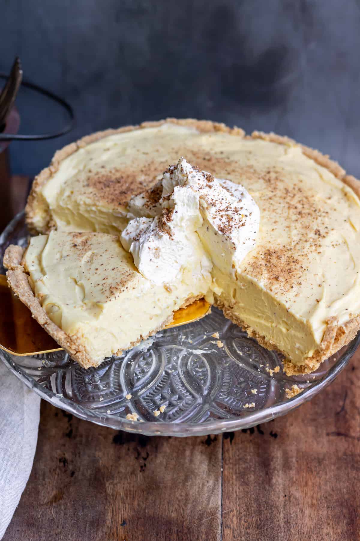 An eggnog pie with a slice being taken out.