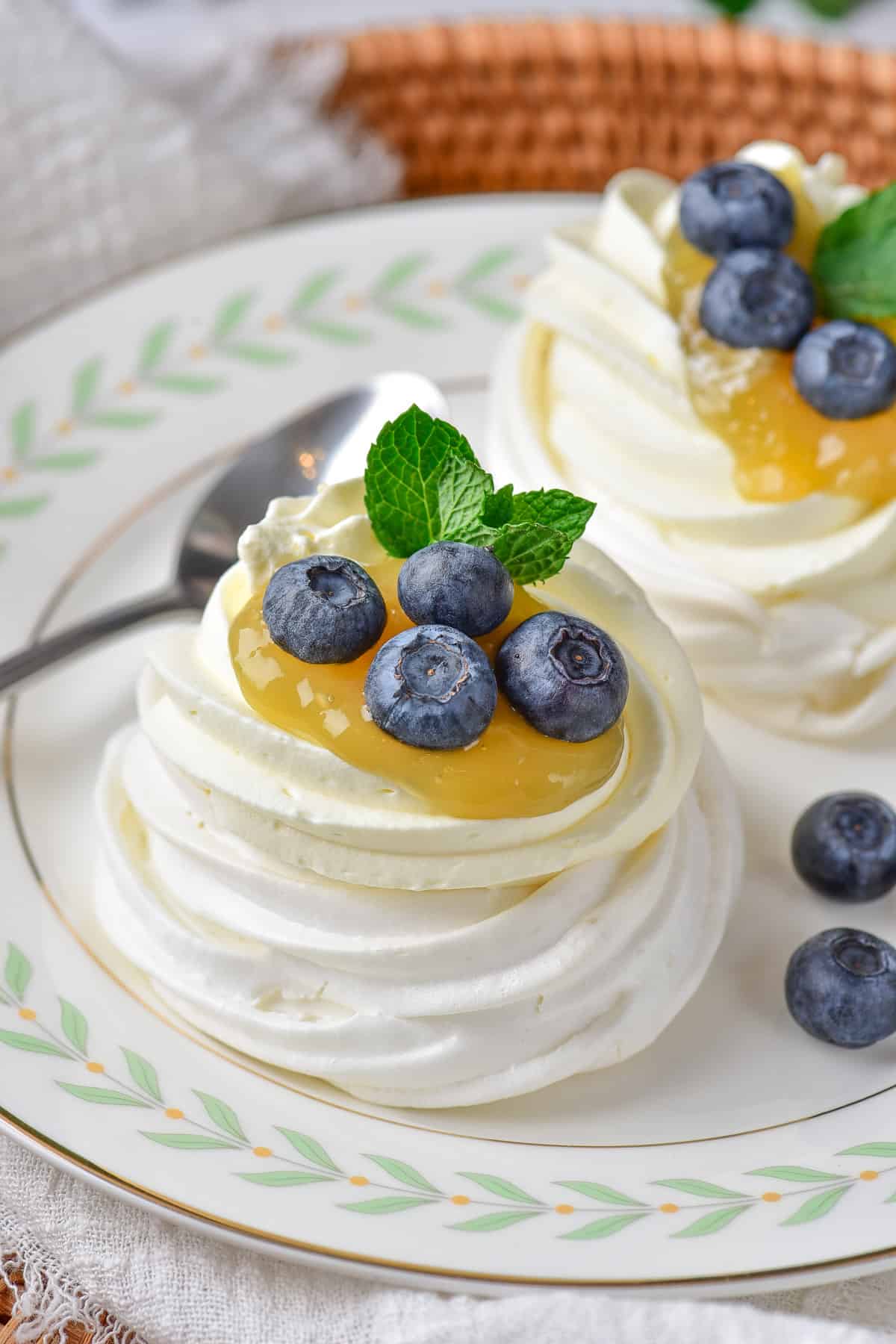 Close up of a mini pavlova with lemon curd and berries.