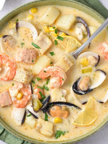 Spoon in a bowl of seafood chowder.