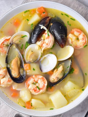 Bowl of seafood soup on a table.